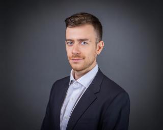 Portrait photo of Arseniy Braslavskiy in professional attire.